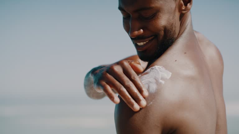 Man applying sunscreen